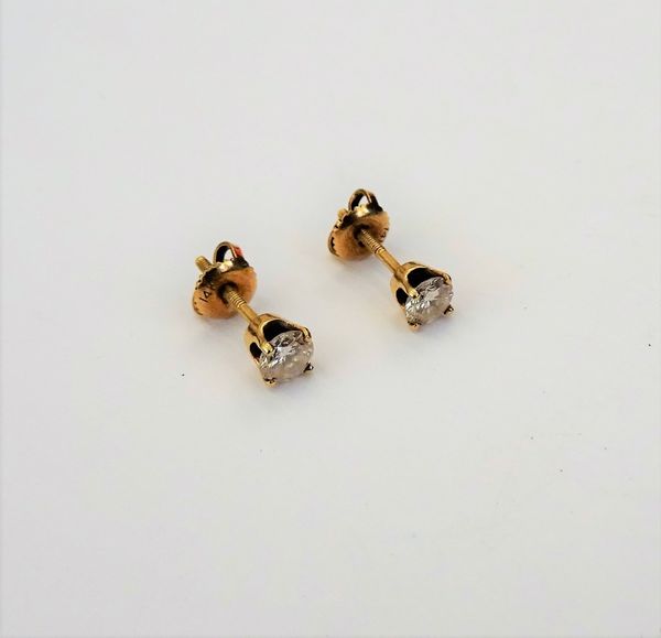 A pair of gold and diamond single stone earstuds, each claw set with a circular cut diamond, the backs with screw post and butterfly fittings, detaile