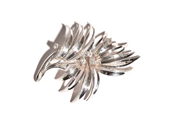 A white gold and diamond brooch, designed as a spray, mounted with seven circular cut diamonds, detailed 750, gross weight 12 gms. 15