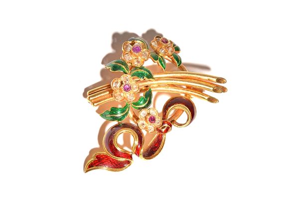 A French gold, diamond and ruby set, green and red enamelled brooch, designed as a floral and foliate spray above a red enamelled scroll, mounted with