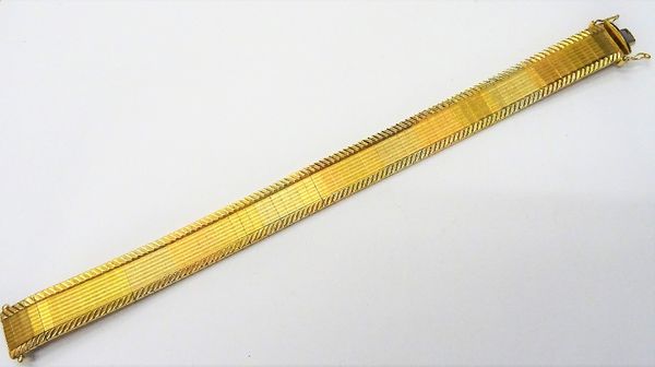 An 18ct three colour gold bracelet, having a textured finish between herring bone engraved sides, on a snap clasp, length 18cm, weight 35.6 gms, with