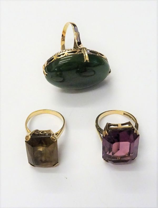 A gold and nephrite single stone ring, a gold ring, claw set with a rectangular cut smoky quartz, detailed 9 C and a 9ct gold and mauve gem set dress