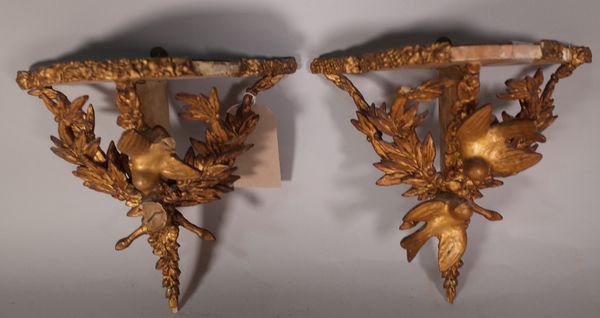 A pair of Victorian style serpentine gilt wood wall shelves, 28cm wide x 30cm high, (2) (a.f.).   ROST