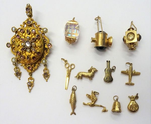 Nine mostly 9ct gold and 9ct gold mounted charms, including; a stork, a fish and an aeroplane, two further charms, comprising; a pair of scissors and