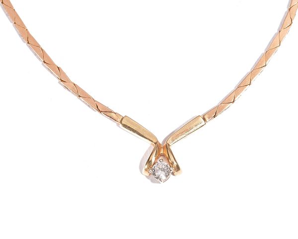 A gold and diamond single stone necklace, claw set with a circular cut diamond to the front, on a snap clasp, detailed M14K, gross weight 11.1 gms.