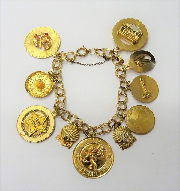 A gold multiple circular link bracelet, fitted with seven gold charms and with three gold plated charms, on a boltring clasp, gross weight including t