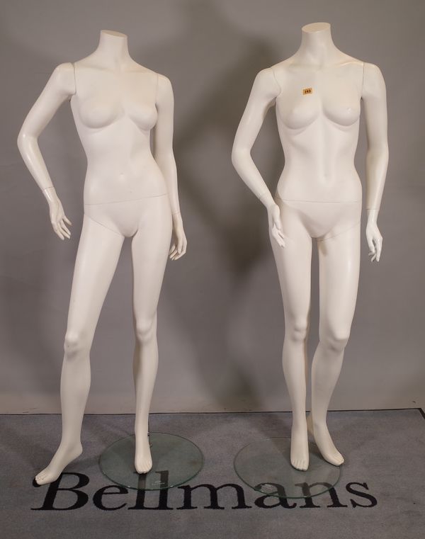 A pair of modern white adult women shop mannequins.  E5