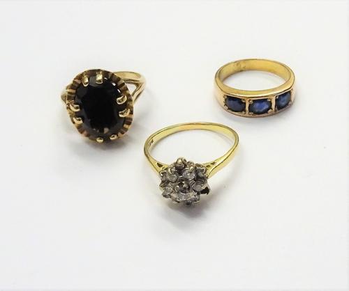 An 18ct gold and diamond cluster ring, mounted with circular cut diamonds, (one diamond lacking), gross weight 3.7 gms, a gold ring, mounted with thre