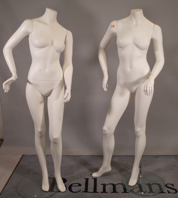 A pair of modern white adult women shop mannequins.  B3