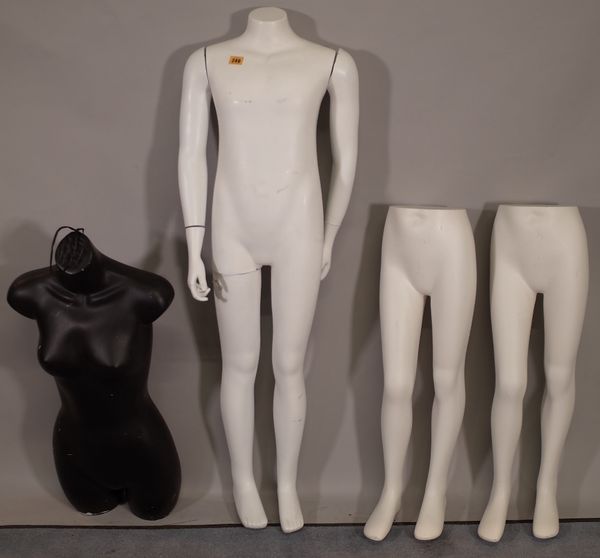 A modern white shop mannequin formed as a child, two sets of child mannequin legs and a black female torso mannequin.  E5