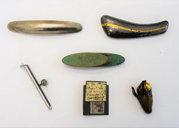 A collection of six modern studio brooches, including a bronze brooch modelled as a hand holding a gilt fruit, a silver brooch, having a beaten finish