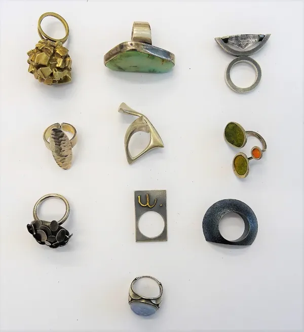 A collection of ten mostly silver rings, in a variety of modern abstract designs, including one mounted with iron pyrites, (10).