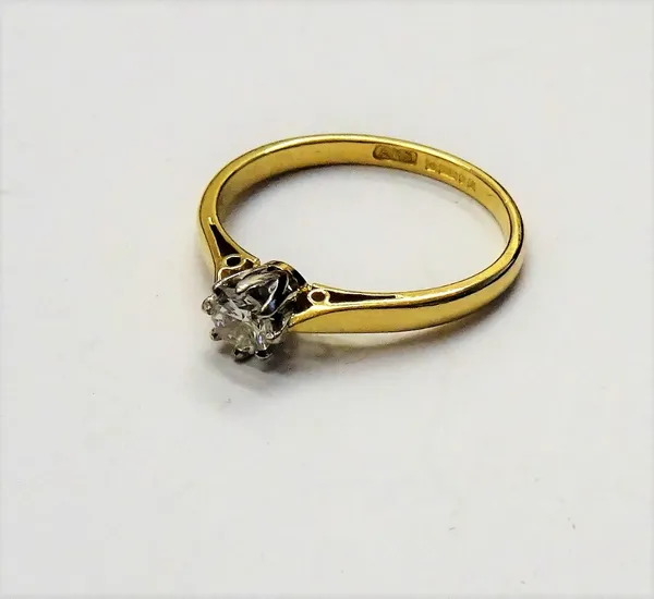An 18ct gold and diamond single stone ring, claw set with a circular cut diamond, detailed 021, ring size L and a half.