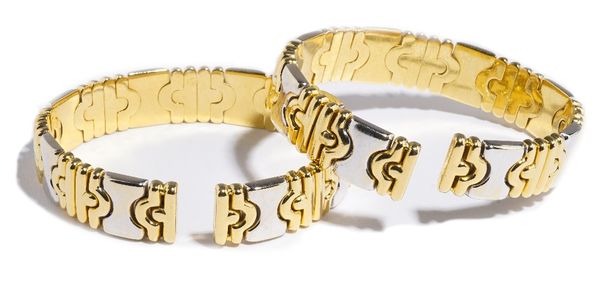 A pair of Italian two colour gold and diamond set sprung bangles, the front of each with diamond set panels, set with circular cut diamonds, alternati