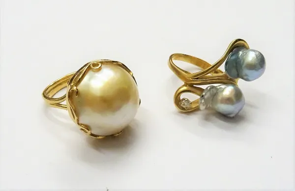 A gold, cultured pearl and diamond set single stone ring, in an abstract twist design, detailed 14 K and a gold ring, mounted with a large mabe pearl,