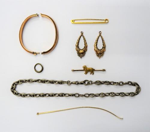 A gold oval hinged bangle, (in two sections), detailed 9 CT, a gold bar brooch with a dog motif, detailed 9 CT, a gold plain bar brooch, detailed 9 CT