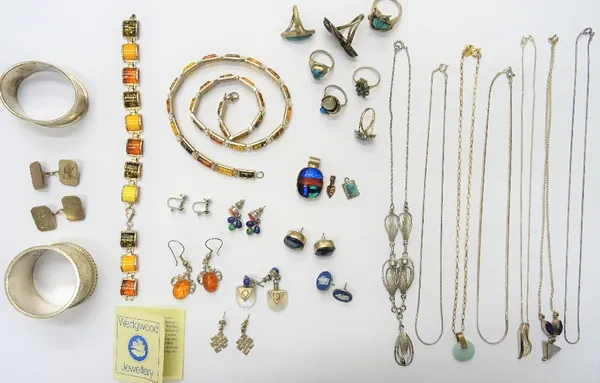 A group of mostly silver jewellery, comprising; seven rings, a reconstituted amber necklace, a reconstituted amber bracelet, three pendants, a pair of