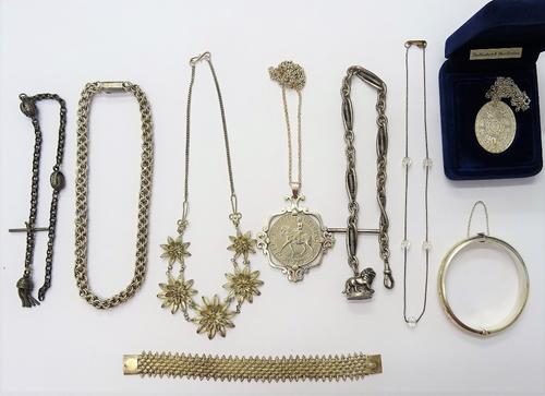 A gentleman's silver watch Albert chain, fitted with a T bar, a swivel and with a silver pendant fob modelled as a lion and further silver and other j