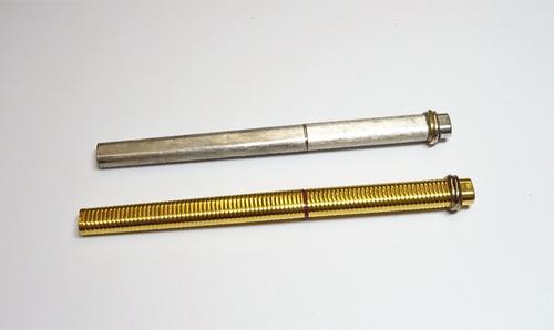 A Cartier Paris gilt metal writing implement, of ridged oval form, detailed Made in France 010 210 and a Cartier Paris silver coloured metal plated ba