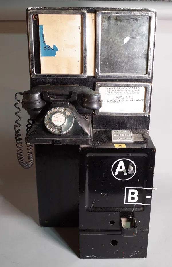 A mid-20th century black painted metal telephone from a phone box, 37cm wide x 76cm high.  B3