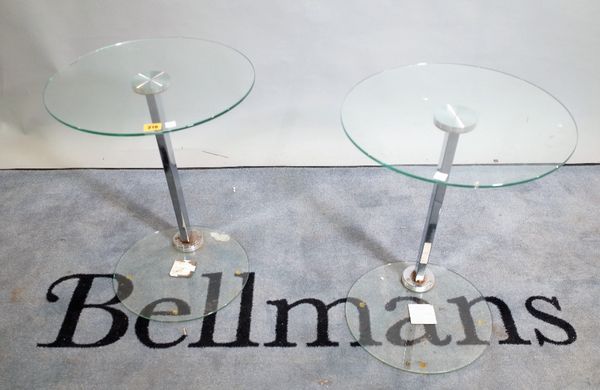 A pair of 20th century chrome and glass occasional tables, on circular glass plinth bases, 43cm wide x 54cm high, (2).   D3