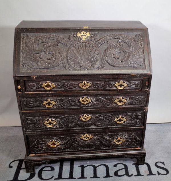 A George III ebonised bureau with four later carved decoration bracket feet, 90cm wide x 107cm high.  E4