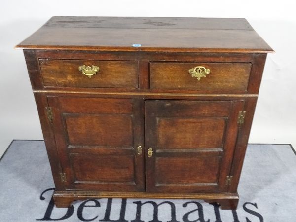 A 19th century and later oak dresser base with two drawers over cupboard base, 104cm wide x 96cm high.   E3