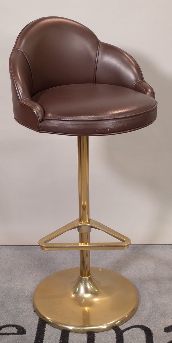 A 20th century brass and leather bar stool, on a circular plinth base, 46cm wide x 102cm high.  D3