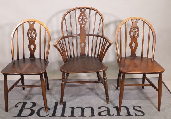 A set of six 20th century Ercol stianed beech stick back dining chairs, 40cm wide x 83cm high and a similar wheelback open armchair, (7).  S6T