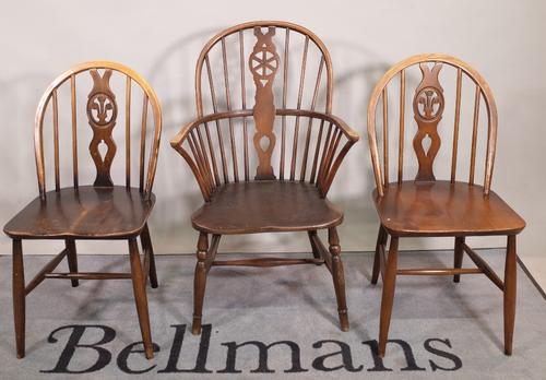 A set of six 20th century Ercol stianed beech stick back dining chairs, 40cm wide x 83cm high and a similar wheelback open armchair, (7).  S6T
