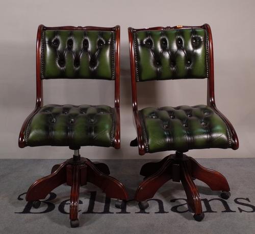 A pair of 20th century office chairs with green button back leather upholstery, 48cm wide x 92cm high, (2).  ROST