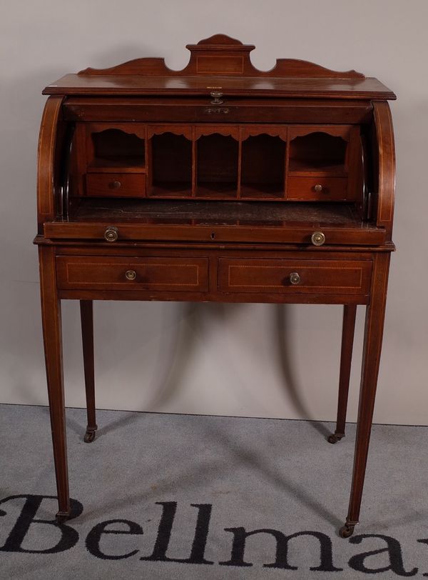 An Edwardian inlaid mahogany cylindrical desk with two short drawers on tapering square supports, 71cm wide x 107cm high.  B2