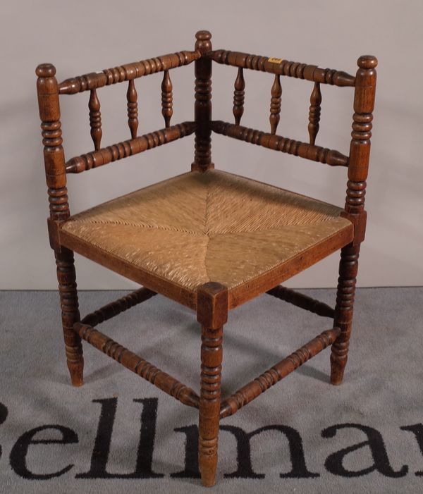 A 19th century stained beech bobbin turned corner chair, 61cm wide x 70cm high.  A2