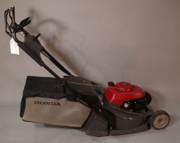 A Honda HRX 476 garden lawn mower.  OUT