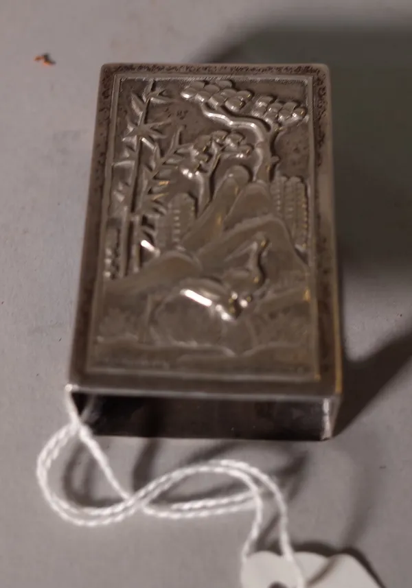 A Chinese export silver matchbox cover, mark of Luen Hing, late 19th/early 20th century, of rectangular form, the top decorated in repoussé with two c