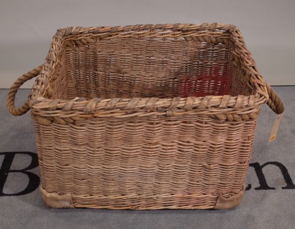 An early 20th century wicker basket with rope handles, 66cm wide x 44cm high.  B2