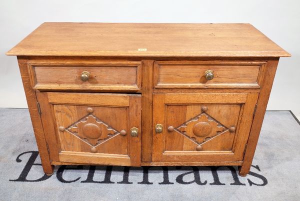 An early 20th century oak low side cupboard panelled doors, 106cm wide x 69cm high.  /C1