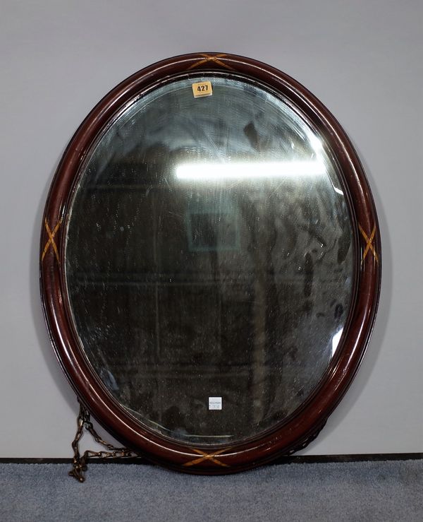 An Edwardian inlaid mahogany oval wall mirror with bevelled glass, 53cm wide x 68cm high.  C5