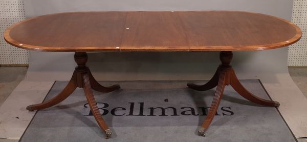 A George III style mahogany D-end dining table, with one extra leaf, on outswept supports, 182cm wide x 75cm high x 226cm fully extended.