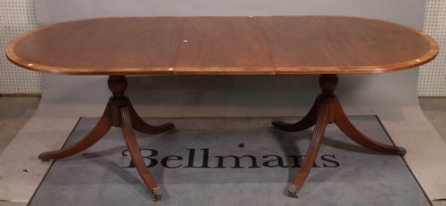 A George III style mahogany D-end dining table, with one extra leaf, on outswept supports, 182cm wide x 75cm high x 226cm fully extended.