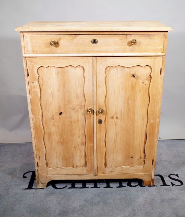 An early 20th century pine side cabinet with single drawer over panelled doors, 93cm wide x 118cm high. D1