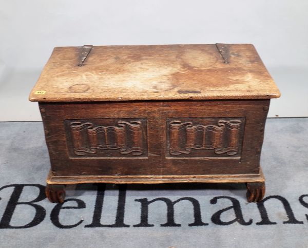 An 18th century style oak lift top box with carved panel decoration, 82cm wide x 48cm high.   D3