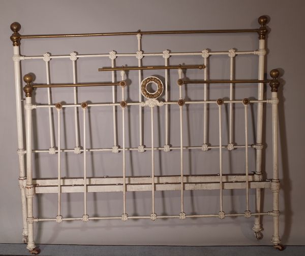 An early 20th century white painted metal double bed, 150cm wide x 140cm high. A1