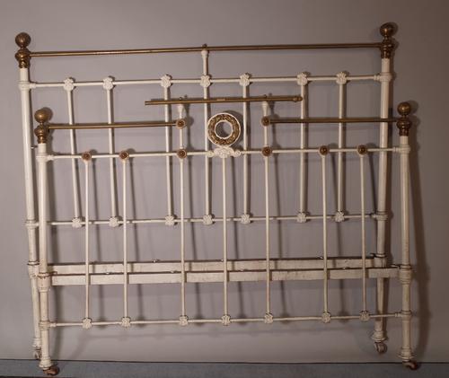 An early 20th century white painted metal double bed, 150cm wide x 140cm high. A1