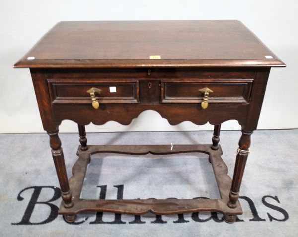 A 17th century style oak single drawer side table with perimeter stretcher, 81cm wide x 78cm high.