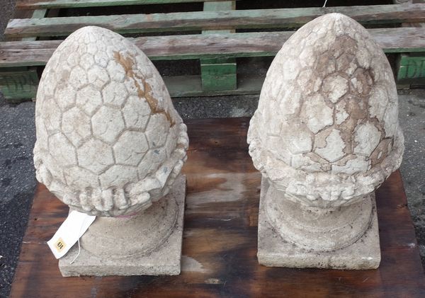 A pair of 20th century reconstituted pine cone finials, on square plinth bases, 54cm high, (2)  A3