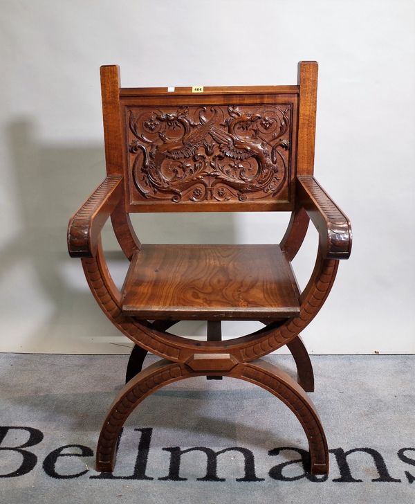 A 19th century Continental walnut 'X' frame open armchair with carved opposing griffin back, 62cm wide x 102cm high.  B1