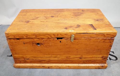 A pine rectangular lift top trunk on plinth base, 90cm wide x 43cm high.   E1