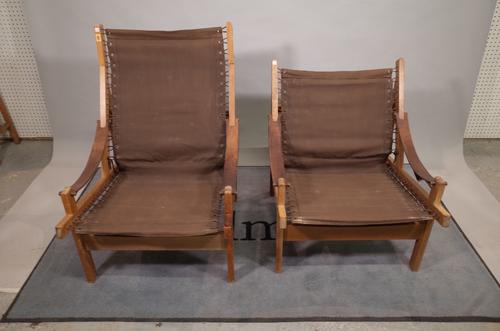 A near pair of 20th century stained beech and canvas low open armchairs, 65cm wide x 98cm high, (2).