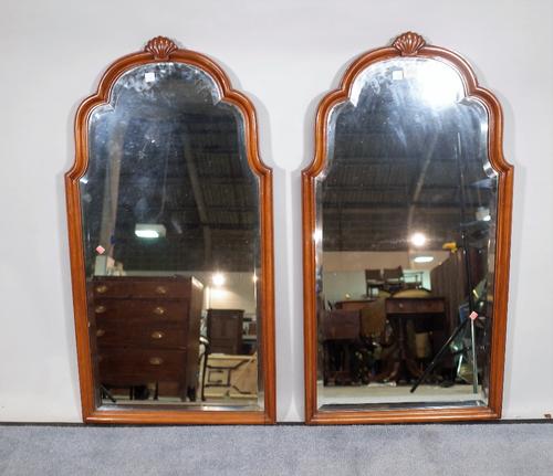 A pair of 20th century mahogany framed arch top wall mirrors, with bevelled glass, 45cm wide x 86cm high, (2).  C5