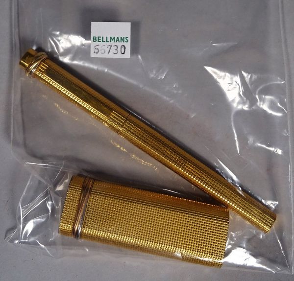 A Cartier gold plated lighter and a matching Cartier ball point pen, (2).   CAB